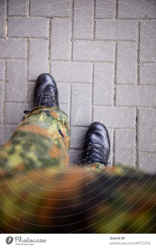 Soldier in uniform Federal armed forces Field suit Spot Camo Boots Movement Going military Uniform War Commitment compulsory military service Germany Anonymous