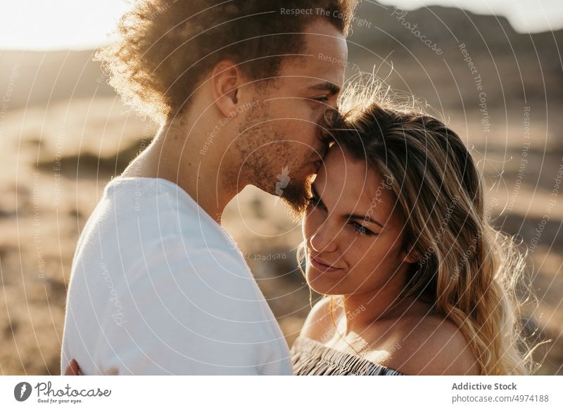 Cheerful couple embracing against highland during sunset embrace love sensual happy hill hipster romantic relationship romance affection girlfriend hug