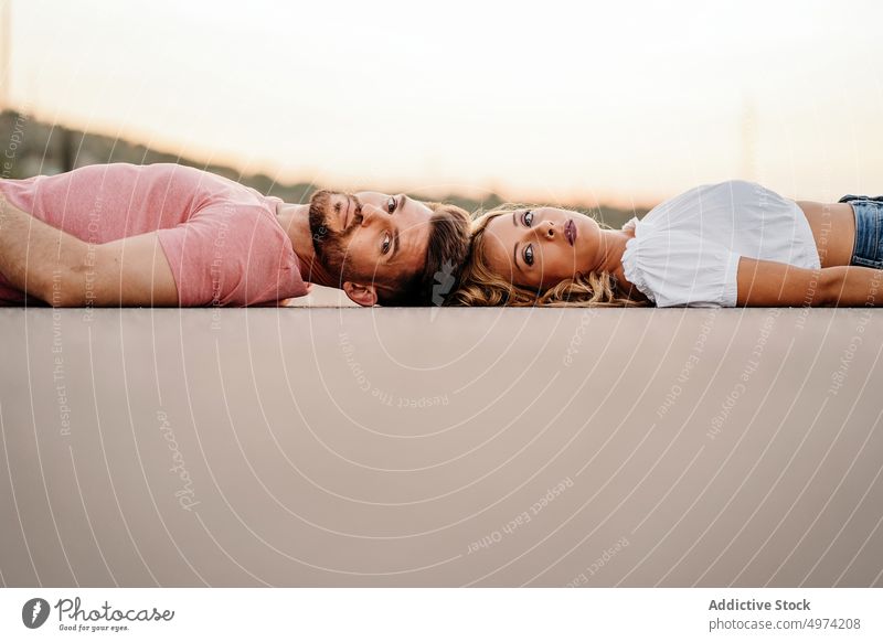 Couple lying down on road and enjoying each other couple love attraction feelings lover harmony bonding yin yang together concept amour street romantic woman