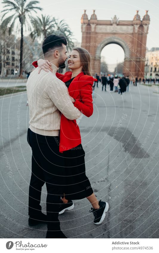 young attractive couple walking in the city urban barcelona hug dating man street people love woman girl female travel lifestyle spain black tourism vacation