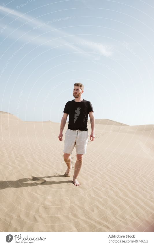 Man standing on sand land and blue sky spain dune hand side desert sunset freedom heaven evening young summer nature picturesque europe landscape travel female
