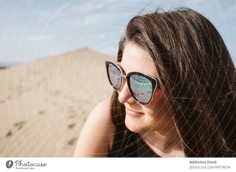Woman looking away on sand land and blue sky at sunset woman portrait spain dune hand side desert freedom heaven evening young summer nature picturesque europe