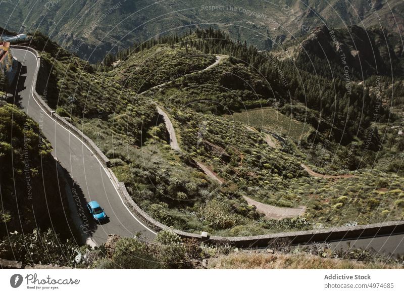 From above mountainous landscape with a road crossing the mountains car outdoor horizontal nature travel crossroad driving journey valley curve copy space