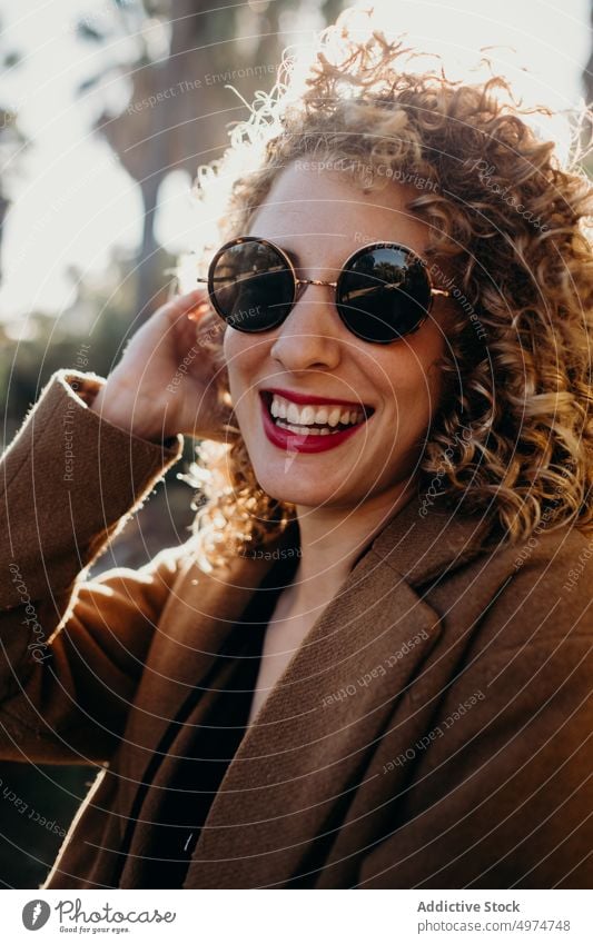 Portrait Of Beautiful Curly Blonde Woman portrait woman fashion sunglasses model glamour face sexy cute accessory apparel beautiful cheerful clothing coat