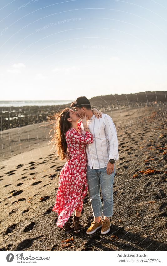 Young man kissing forehead of girlfriend with closed eyes in nature couple touch face romantic eyes closed love field together affection date calm fondness