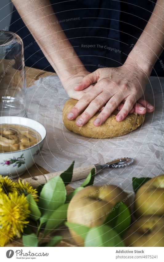 Crop person kneading dough for pastry table press apple ingredient kitchen fresh food prepare cook homemade organic meal natural recipe rustic cuisine nutrition