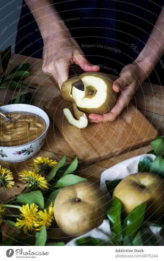 Crop person peeling apple over table cook kitchen home knife dessert fresh food fruit organic vegetarian vegan rustic cutting board tool dandelion homemade
