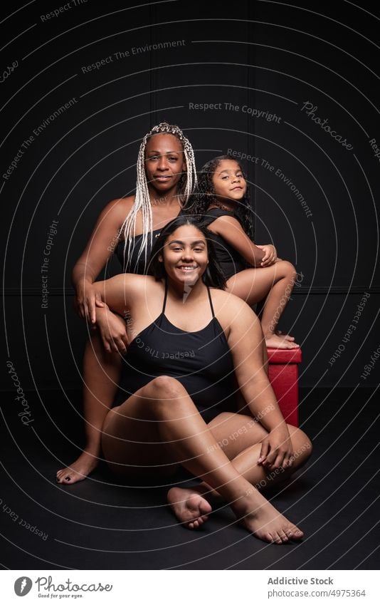 Multiracial women and kid in bodysuits body positive diverse group plus size happy different multi generational portrait concept female multiethnic multiracial
