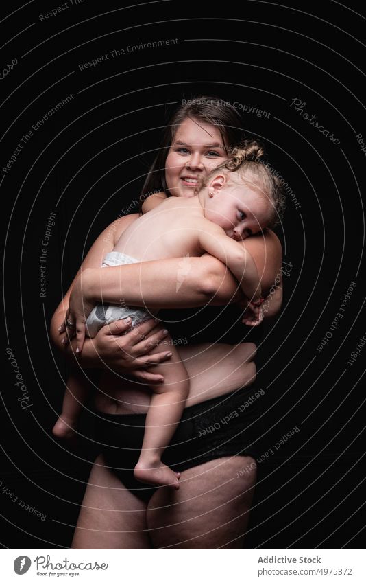 Happy overweight mother with baby woman plus size happy love together hug smile portrait positive female child kid mom plump body positive concept imperfect