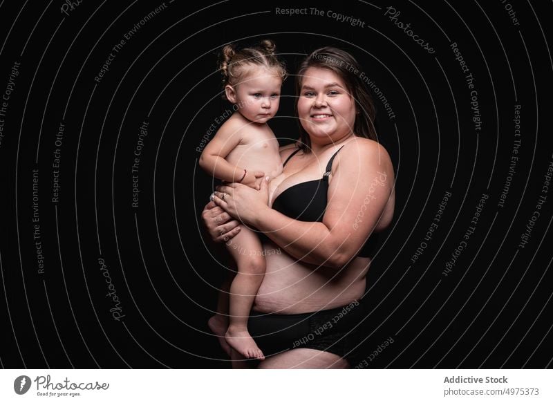 Happy overweight mother with baby woman plus size happy love together hug smile portrait positive female child kid mom plump body positive concept imperfect