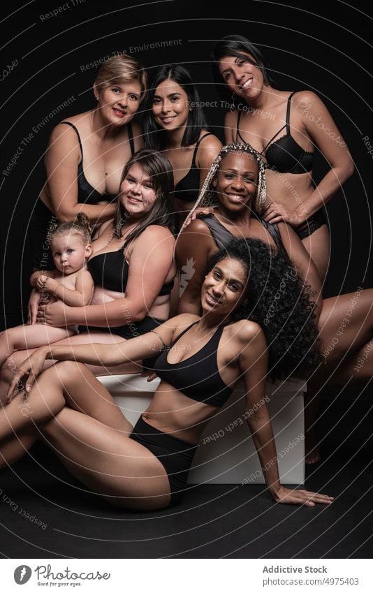 Positive multiracial women in underwear with baby diverse group body positive happy mother different portrait concept female slim plus size multiethnic black