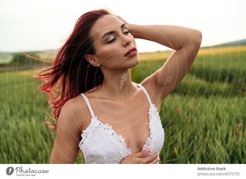 Sensitive woman in wheat field against mountains sensitive touch head gentle natural beauty sundress farmland sky highland dreamy white color green countryside