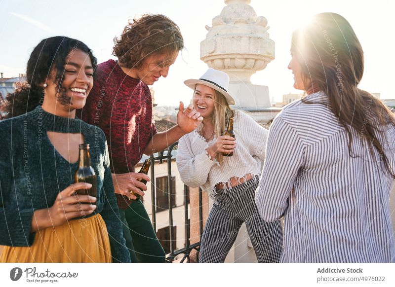 Joyful diverse friends with beer dancing on rooftop dance terrace alcohol party having fun excited hangout cheerful happy together gather drink celebrate