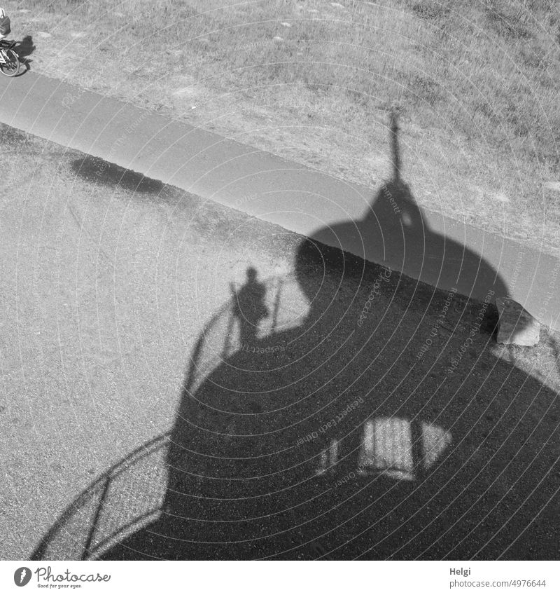 Shadow existence - shadow of a lookout tower with a person standing on the railing shadow cast Tower Lookout tower Silhouette Light Sunlight cycle path cyclists