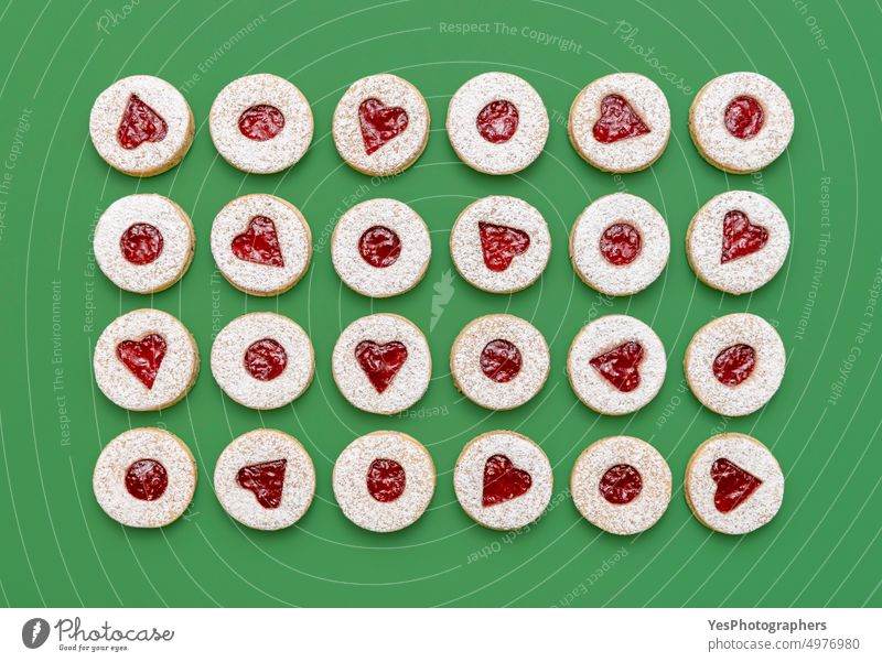 Linzer Christmas cookies top view on a green background. above aligned austrian baked biscuit christmas color confectionery cuisine december decoration