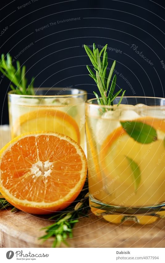 Glass of orange lemonade on dark background refreshment summer beverage drink juice alcohol vitamin tropical taste sweet slice rosemary ripe organic natural