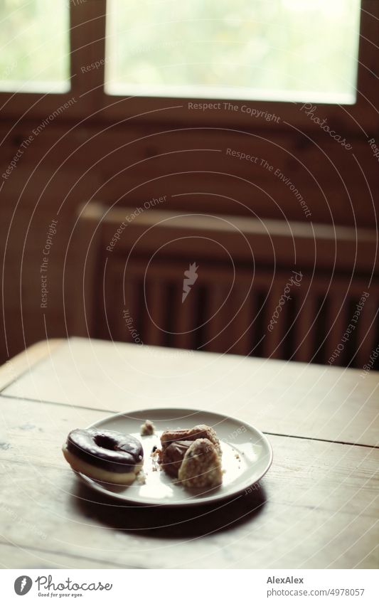 Plate with cake - muffin - donut - stands on a wooden table in a garden shed in front of the window Table Wooden table Cake doughnut Muffin cute Food Tartlet