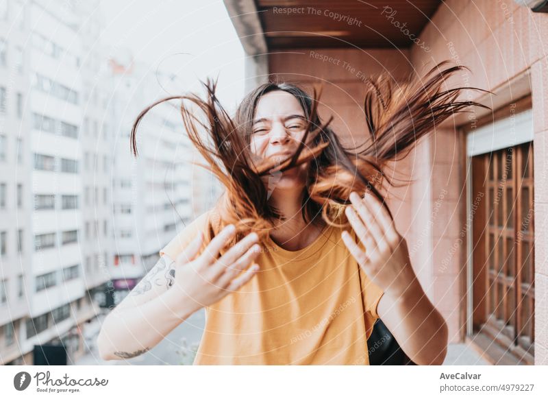 Young woman smiling,laughing and waving hair with hands looking camera.Fresh college student nervous and excited for new university,lessons and house.Starting era and lifestyle in city,generation z
