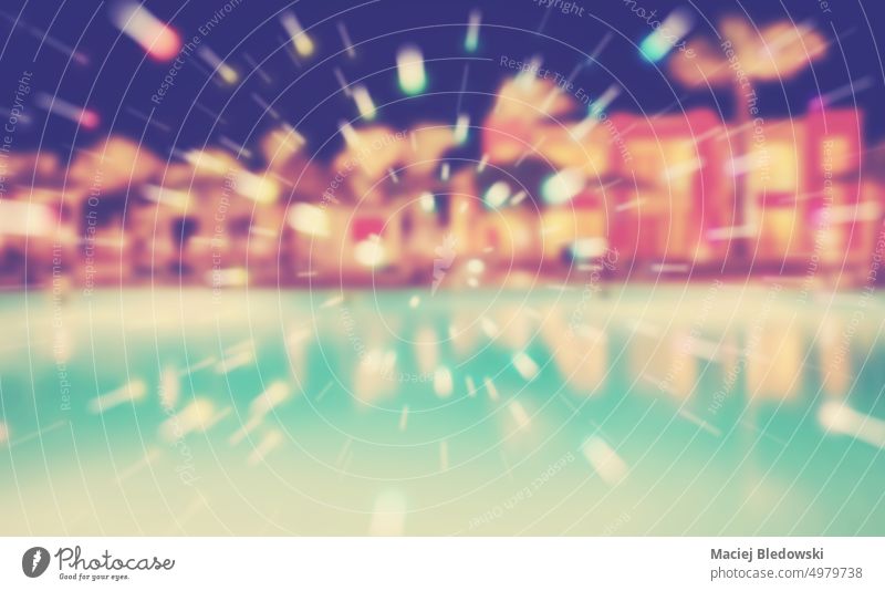 Blurred picture of a swimming pool at night, color toning applied. party abstract light blurred resort nightlife background shine bright glow de focused holiday