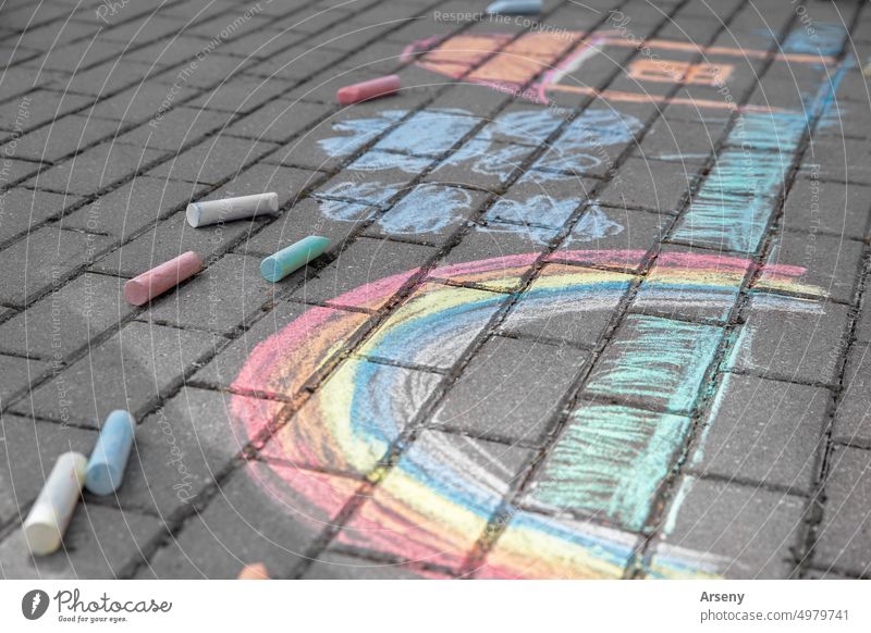 Rainbow with grass, house and clouds painted in colored chalk on a path on the street outdoor art draw activity childhood colorful creative play rainbow school