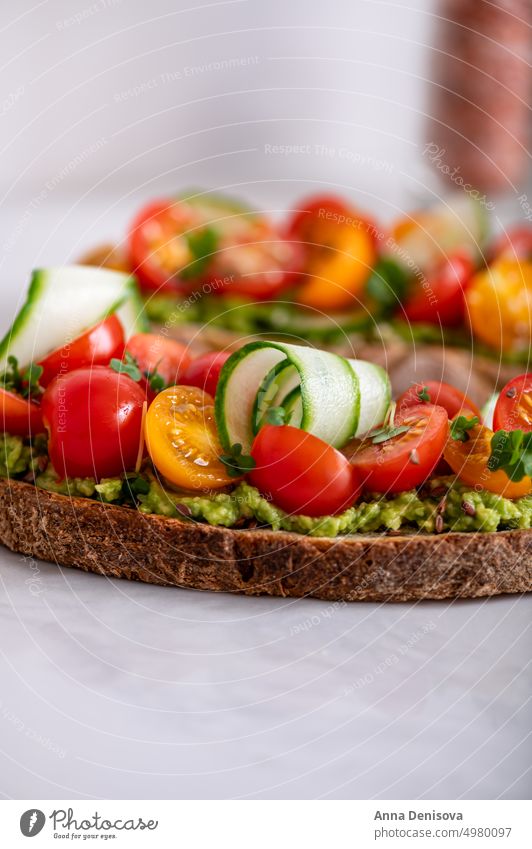 Toast with cherry tomatoes and avocado toast mashed cucucmber bread micro greens lunch breakfast fresh food vegetarian healthy delicious snack gourmet meal