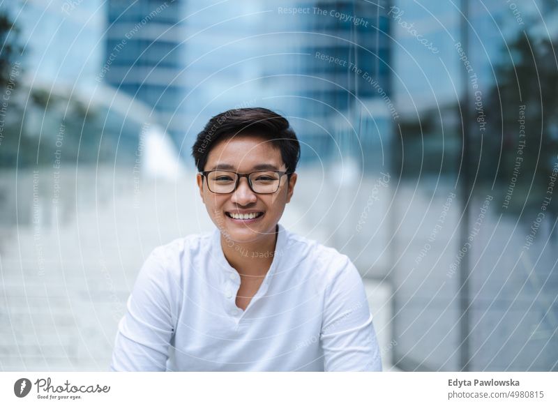 Portrait of a smiling young man in the city real people natural young adult urban student positive smile cheerful career confident successful business person