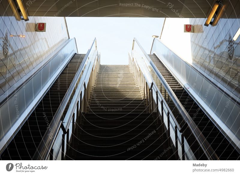 Staircase with escalators of a metro station in summer under blue sky and sunshine in the Erenköy district of Kadiköy in Istanbul on the Bosporus in Turkey