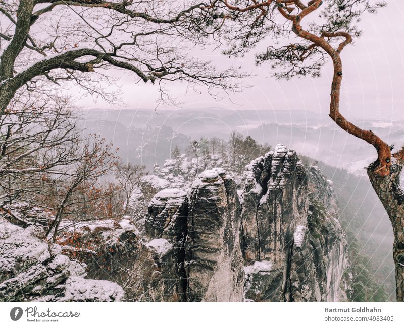 View from the Basteiaussicht to the snowy rocky landscape of Saxon Switzerland. Landscape Winter Snow mountains Rock Nature Season Tourist Attraction