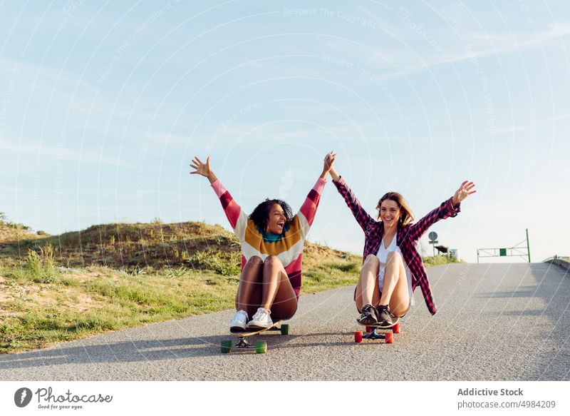 Beautiful skaters practicing riding skate board on street woman skateboard fun beautiful young trendy stylish youth skateboarder lifestyle girl summer female