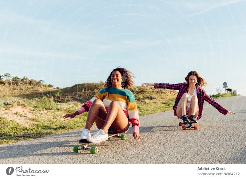 Beautiful skaters practicing riding skate board on street woman skateboard fun beautiful young trendy stylish youth skateboarder lifestyle girl summer female