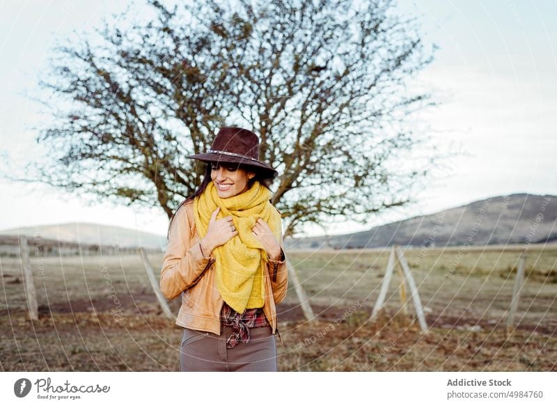 Stylish woman in scarf and cowboy hat beautiful style ranch nature standing cowgirl trendy thoughtful dreaming brunette harmony fence young landscape wood