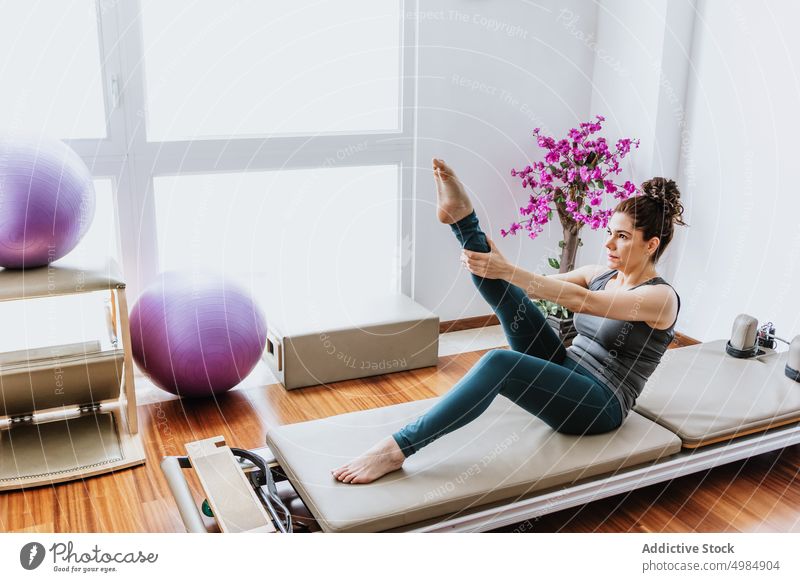 Woman doing sit-ups at home woman yoga wellness balance healthy wellbeing practice female young fit sportswear barefoot stress relief zen sportswoman
