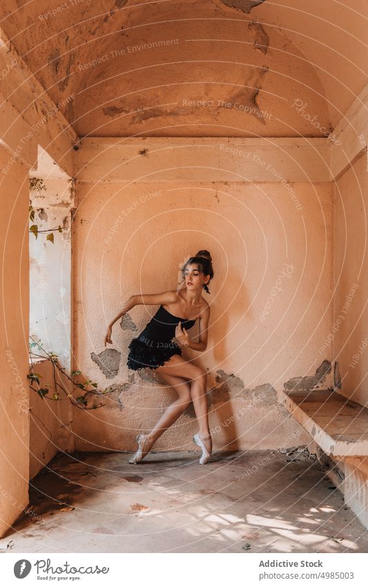 Young ballerina posing with a black dress ballet dancer young beautiful shoes interior woman modern classical tiptoe people pose female girl artist caucasian