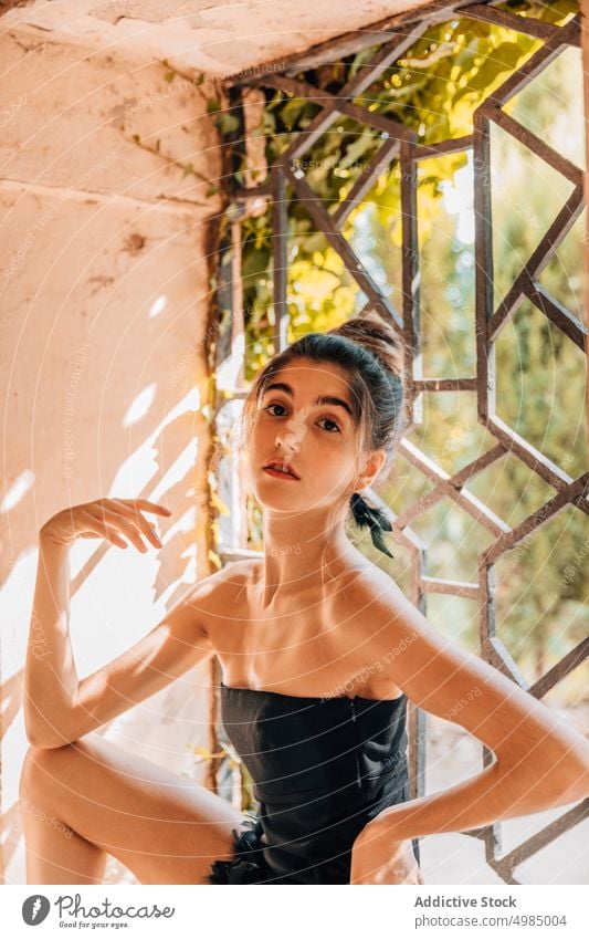 Portrait of a ballerina by the window ballet young girl classical dancer female light woman portrait caucasian style elegance professional dress black frame