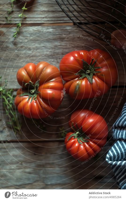 Ripe tomatoes on table ripe red rustic culinary layout wood vegetable herb napkin dinner delicious ingredient vegetarian striped vitamin vegan cooking recipe