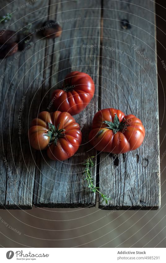Ripe tomatoes on table ripe red rustic culinary layout wood vegetable herb napkin dinner delicious ingredient vegetarian striped vitamin vegan cooking recipe