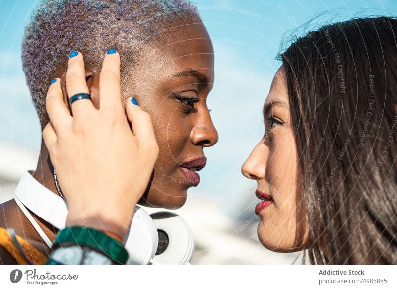 Couple of multiethnic lesbian women looking at each other couple relationship lgbt girlfriend love homosexual together same sex multiracial diverse black