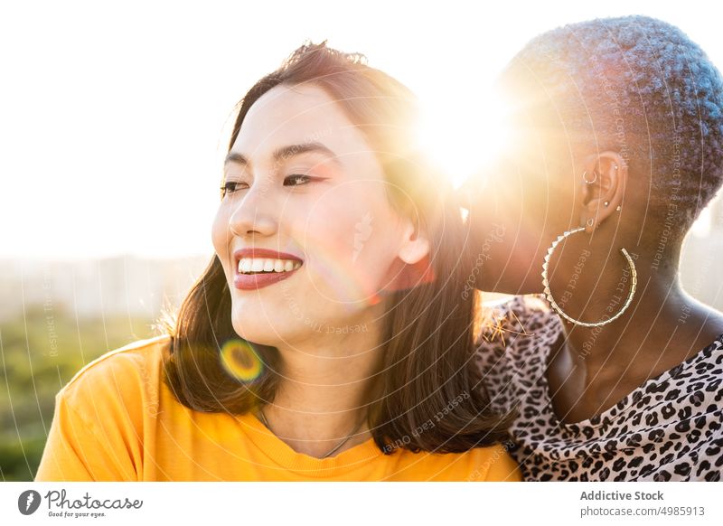 Multi ethnic lesbian couple hugging outdoors affection bonding touch lgbt homosexual togetherness young multi ethnic multiracial asian female beautiful