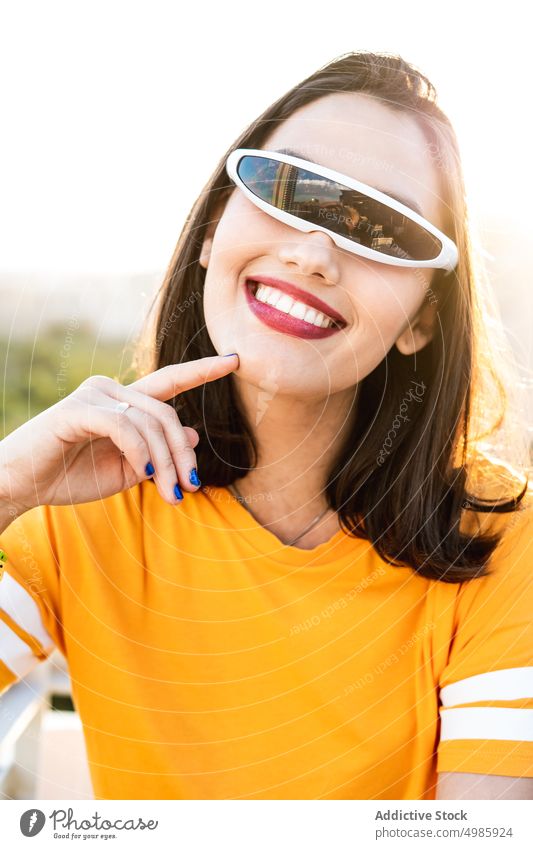 Smiling woman in stylish futuristic sunglasses summer style trendy cheerful fashion cyber female modern young happy smile cool joy positive charming city urban