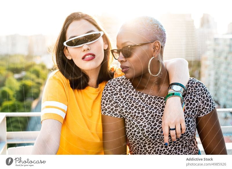 Stylish couple of multiracial lesbian women embracing in street hug trendy cool love lgbt sunglasses girlfriend embrace multiethnic diverse black