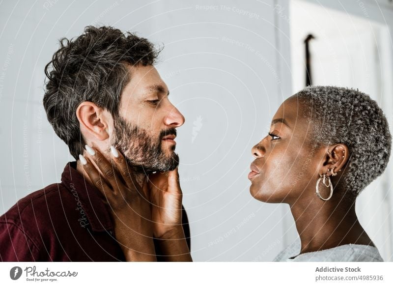 Multiethnic lovers at home couple relationship casual hug intimate cuddle embrace together romantic close valentine allure affection multiethnic