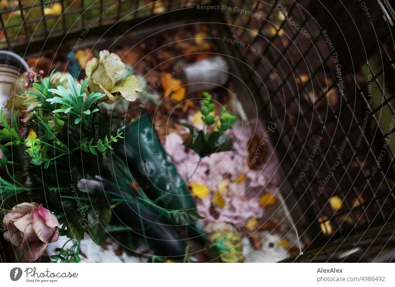 HH Tour Unnamed Street | metal trash can with discarded plastic flowers Trash rubbish bin Trash container Lattice basket metal grid Grating Plastic flowers