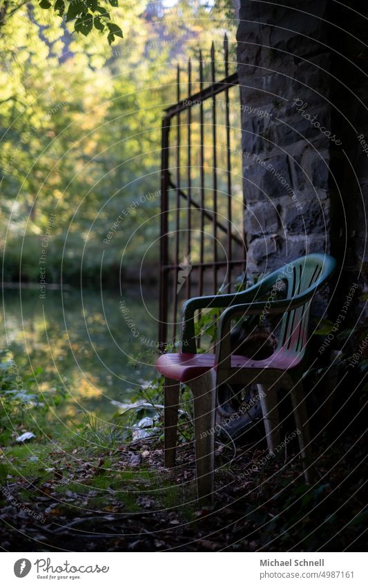 Lonely colorful plastic chair by a river (Lenne, North Rhine-Westphalia, Germany) Chair Plastic chair Sit Seating tranquillity relaxation Empty forsake sb./sth.