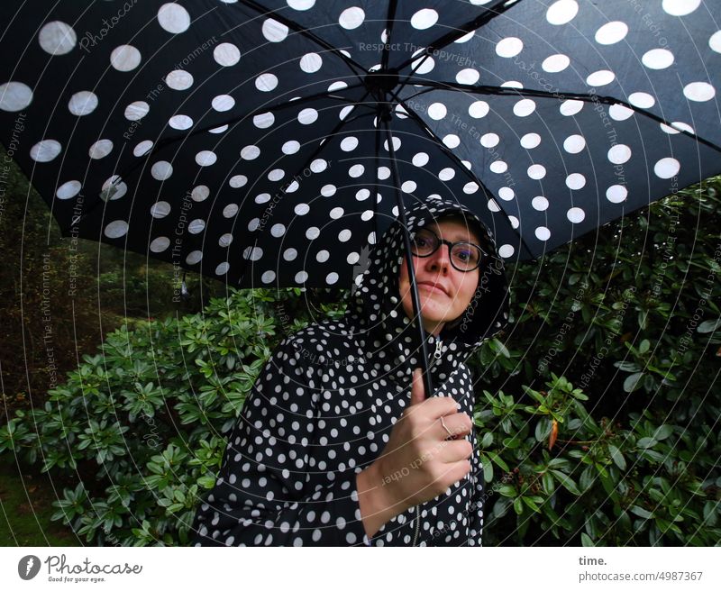 Unnamed Road Tour | Point Winner Woman Umbrellas & Shades Spotted Rain jacket Park bush Eyeglasses Looking into the camera feminine stop Bad weather
