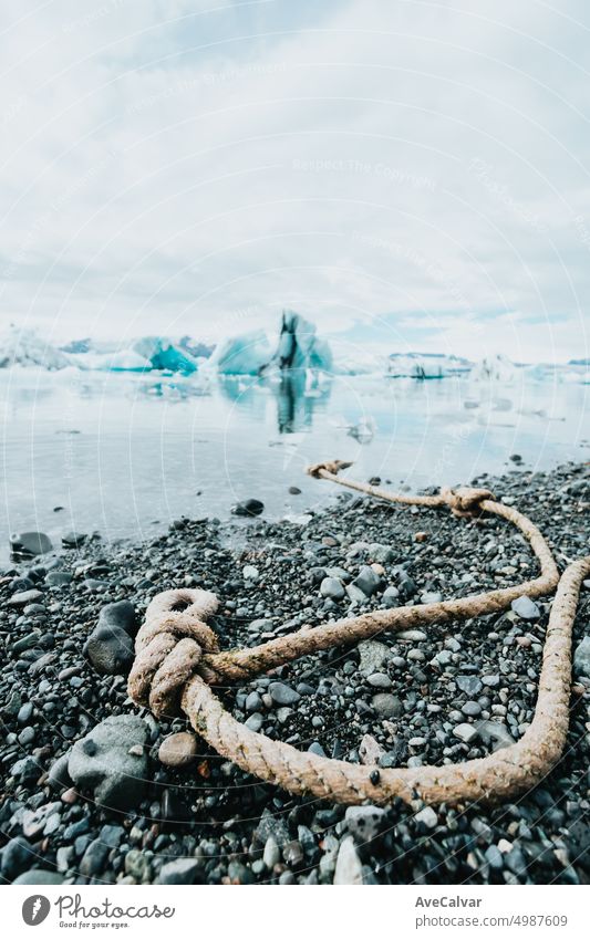 Vatnajokull iceberg glacier during a clear day at iceland, rope on the shore for ships. person lagoon climate arctic glacial hiking north woman awe calmness
