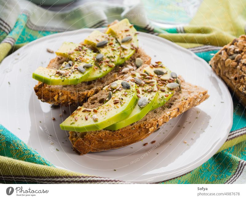 Avocado sandwich for healthy snack with seeds avocado toast slice food vegetable bread cereal whole grain pumpkin flex eat appetizer vegetarian breakfast lunch