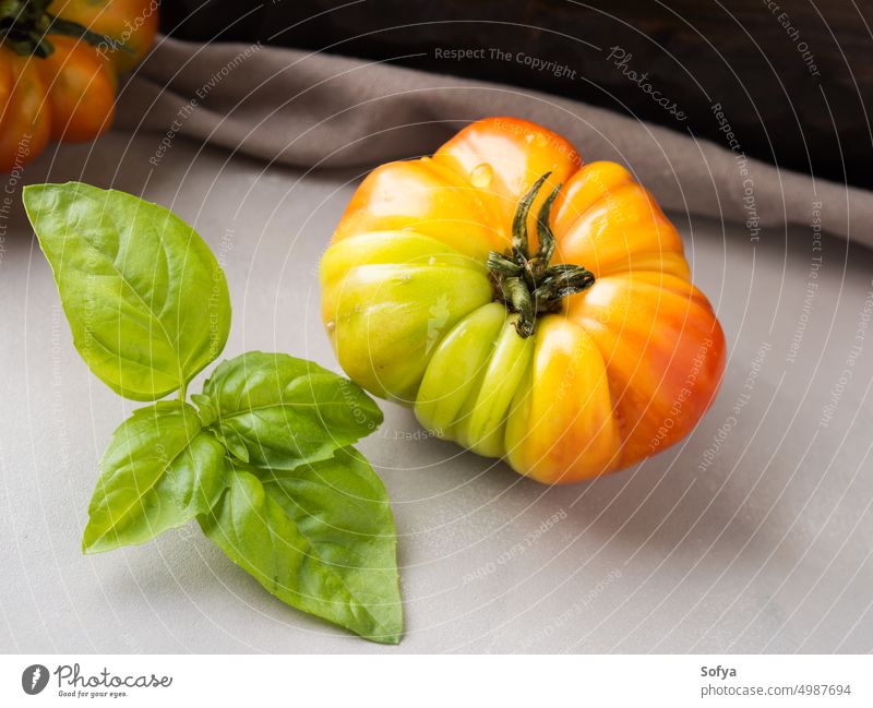 Italian salad tomato with basil on table cloth italian cuisine cook uncooked caprese sauce local gray rustic wooden board eat gourmet delicious green vegetable