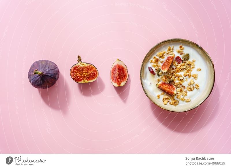 A bowl of cereal, yogurt and figs on a pink background. Breakfast. Cereal Yoghurt Fig cute Nutrition Oat flakes porridge Diet Healthy Fruit Food Bowl Organic