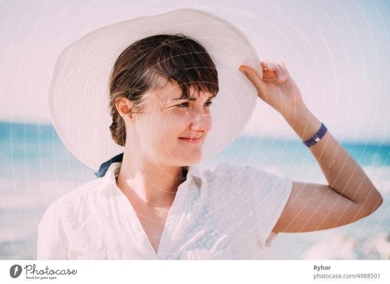Young Caucasian Lady Woman In Summer Hat Posing Near Sea Beach. Close Up Portrait. Vacation On Sea Ocean Beach authentic beach beautiful beauty caucasian enjoy