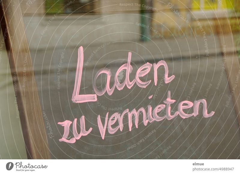 Store for rent - is written in pink letters on a board behind the shop window / business closure Rental offer business discontinuation Window broke bankrupt